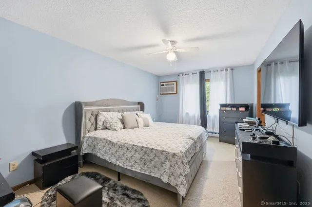 a bedroom with a bed and a chandelier
