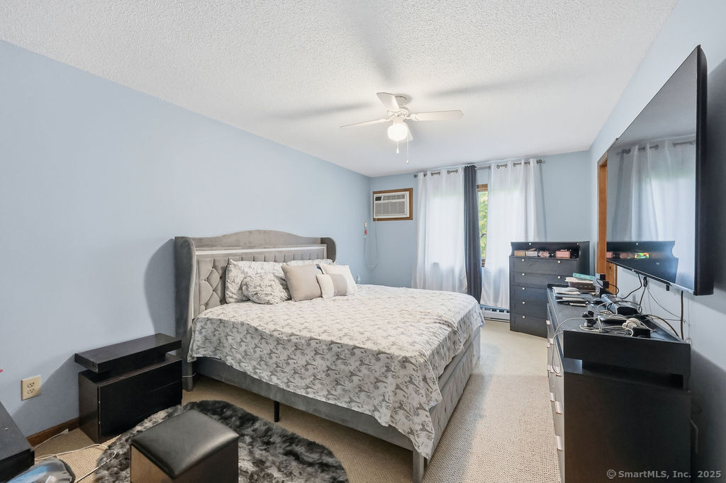 25 Washington Street, Unit 20 Bristol, CT 06010 - Photo 17 of 29 a bedroom with a bed and a chandelier