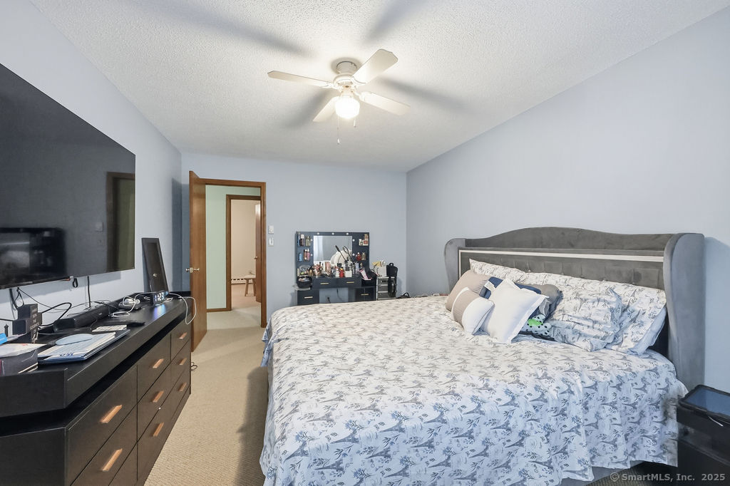 25 Washington Street, Unit 20 Bristol, CT 06010 - Photo 18 of 29 a bedroom with a bed and a chandelier