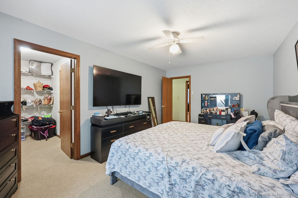 25 Washington Street, Unit 20 Bristol, CT 06010 - Photo 19 of 29 a bedroom with a bed and a flat tv screen on dresser