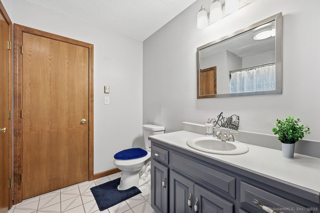 25 Washington Street, Unit 20 Bristol, CT 06010 - Photo 20 of 29 a bathroom with a sink toilet and mirror