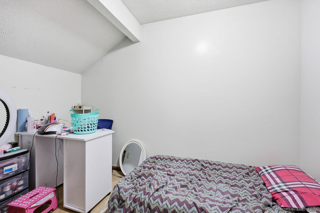 25 Washington Street, Unit 20 Bristol, CT 06010 - Photo 23 of 29 a bedroom with a bed and a dresser in it