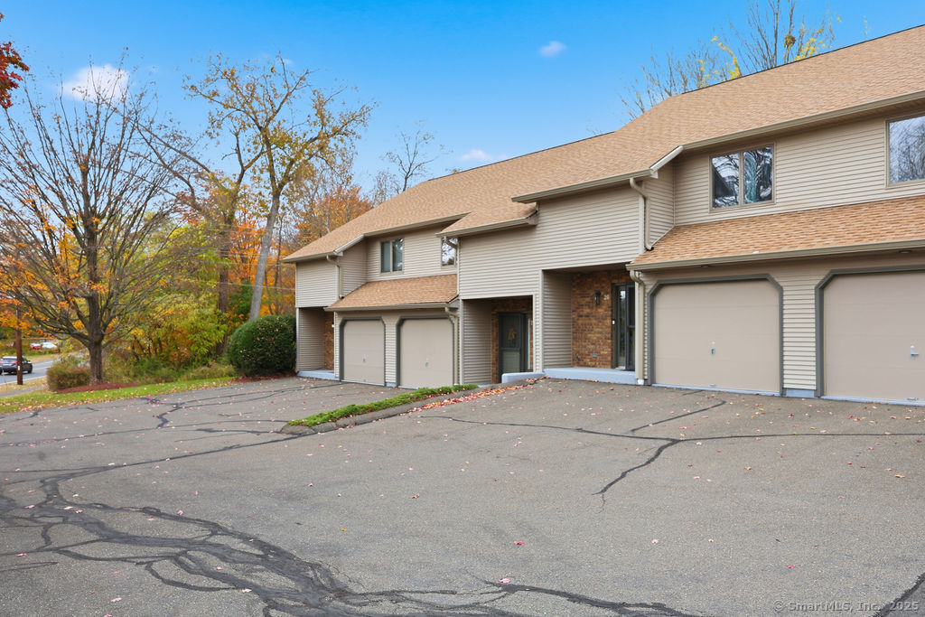 25 Washington Street, Unit 20 Bristol, CT 06010 - Photo 28 of 29 a front view of a house with a yard and garage