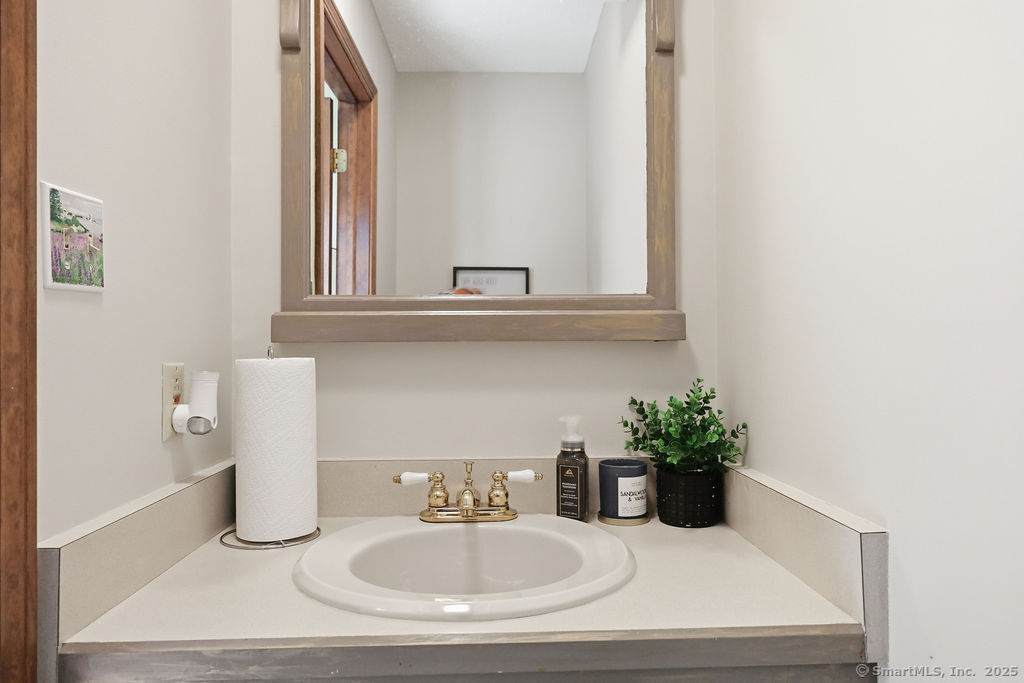 25 Washington Street, Unit 20 Bristol, CT 06010 - Photo 5 of 29 a bathroom with a sink and a mirror