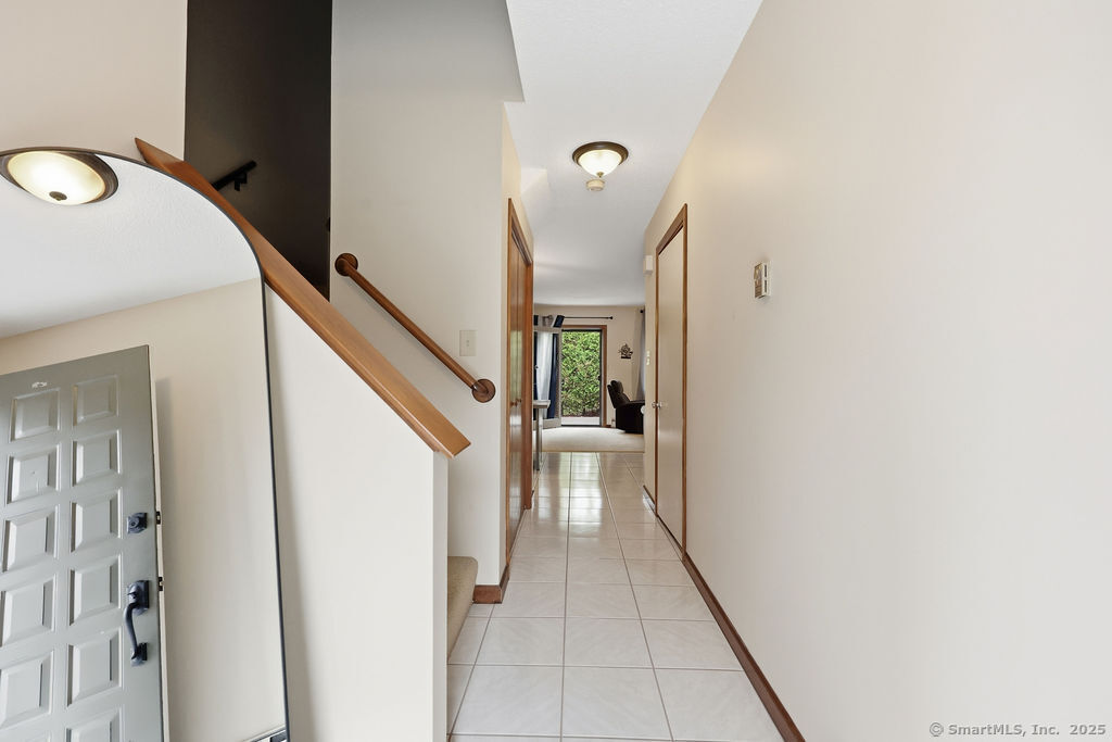 25 Washington Street, Unit 20 Bristol, CT 06010 - Photo 6 of 29 a view of a hallway with wooden floor and staircase