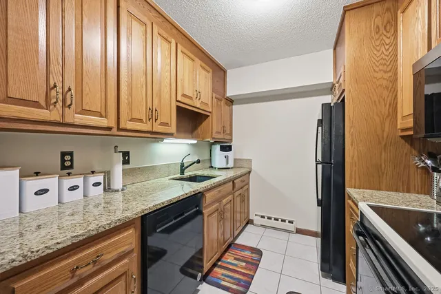 a kitchen with stainless steel appliances granite countertop a refrigerator stove and sink