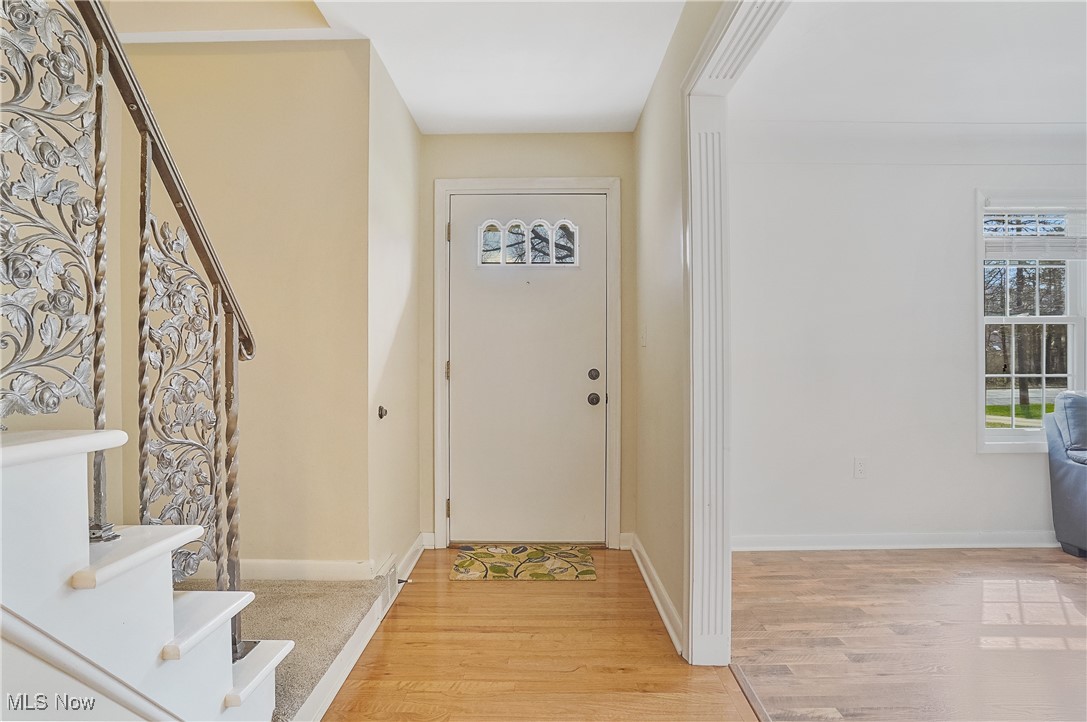 33825 Cannon Road Solon, OH 44139 - Photo 19 of 44 Entryway featuring stairs, light wood-type flooring, and baseboards