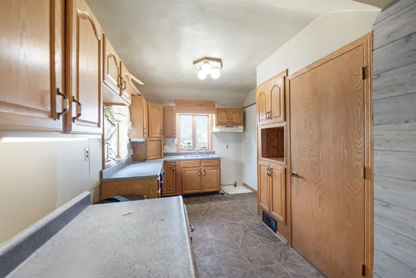 a view of a room with wooden floor and window
