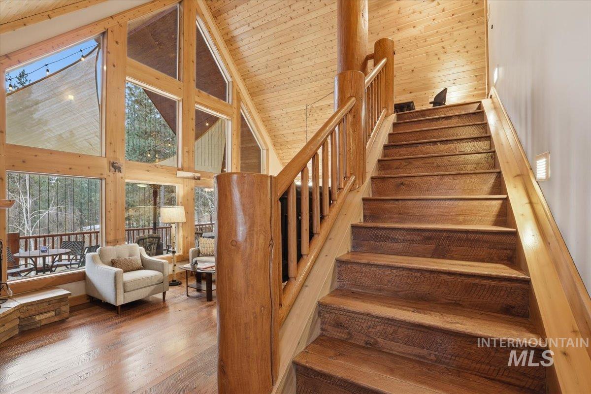 20 Valley High Road Garden Valley, ID 83622 - Photo 17 of 46 Stairway with a high ceiling, wood-type flooring, wood ceiling, and wood walls