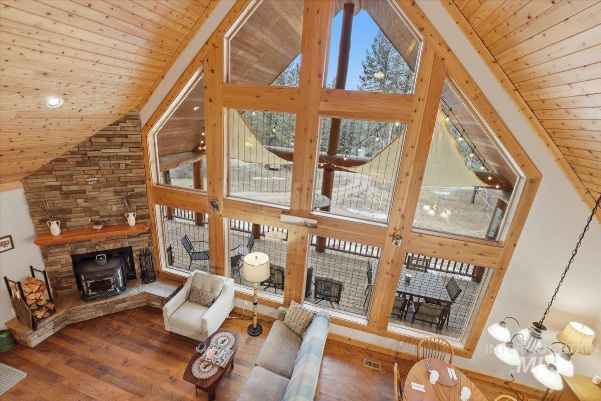 20 Valley High Road Garden Valley, ID 83622 - Photo 18 of 46 Living room featuring high vaulted ceiling, wood ceiling, wood-type flooring, and a fireplace