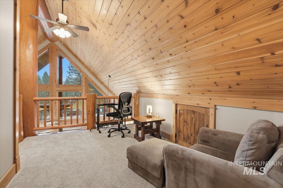 20 Valley High Road Garden Valley, ID 83622 - Photo 20 of 46 Living area featuring lofted ceiling, wood ceiling, carpet, an upstairs landing, and a ceiling fan