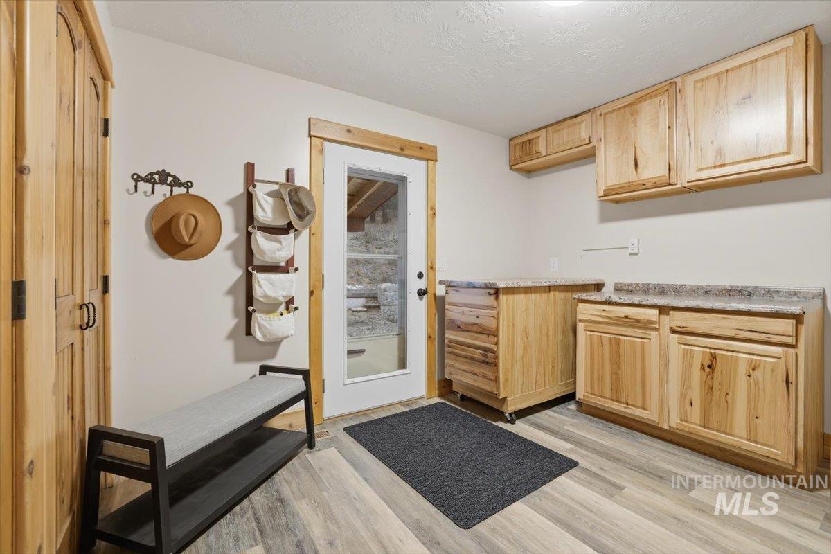 20 Valley High Road Garden Valley, ID 83622 - Photo 30 of 46 Kitchen featuring light brown cabinets, light wood-style floors, light countertops, and a textured ceiling