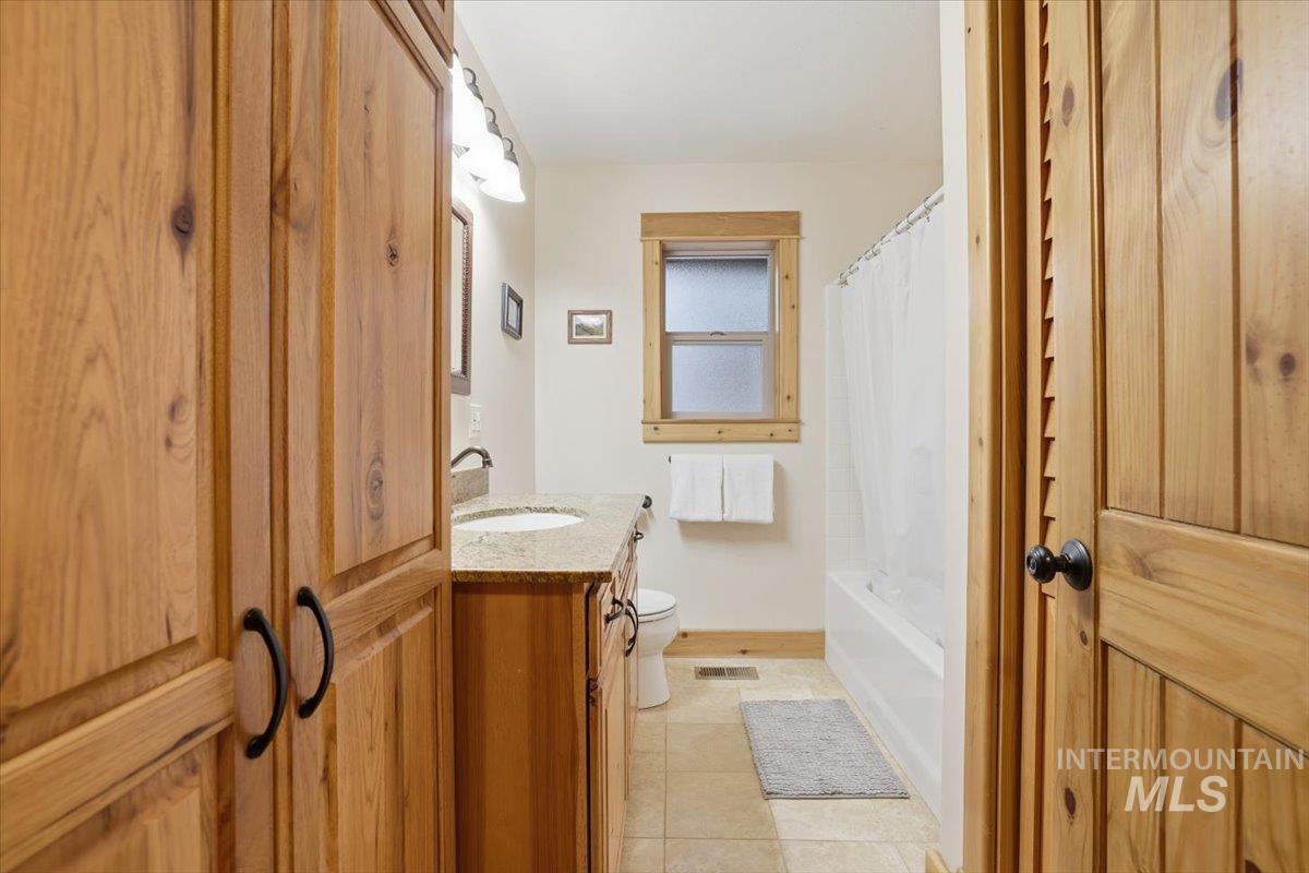 20 Valley High Road Garden Valley, ID 83622 - Photo 33 of 46 Bathroom featuring vanity, shower / bath combo, and light tile patterned floors