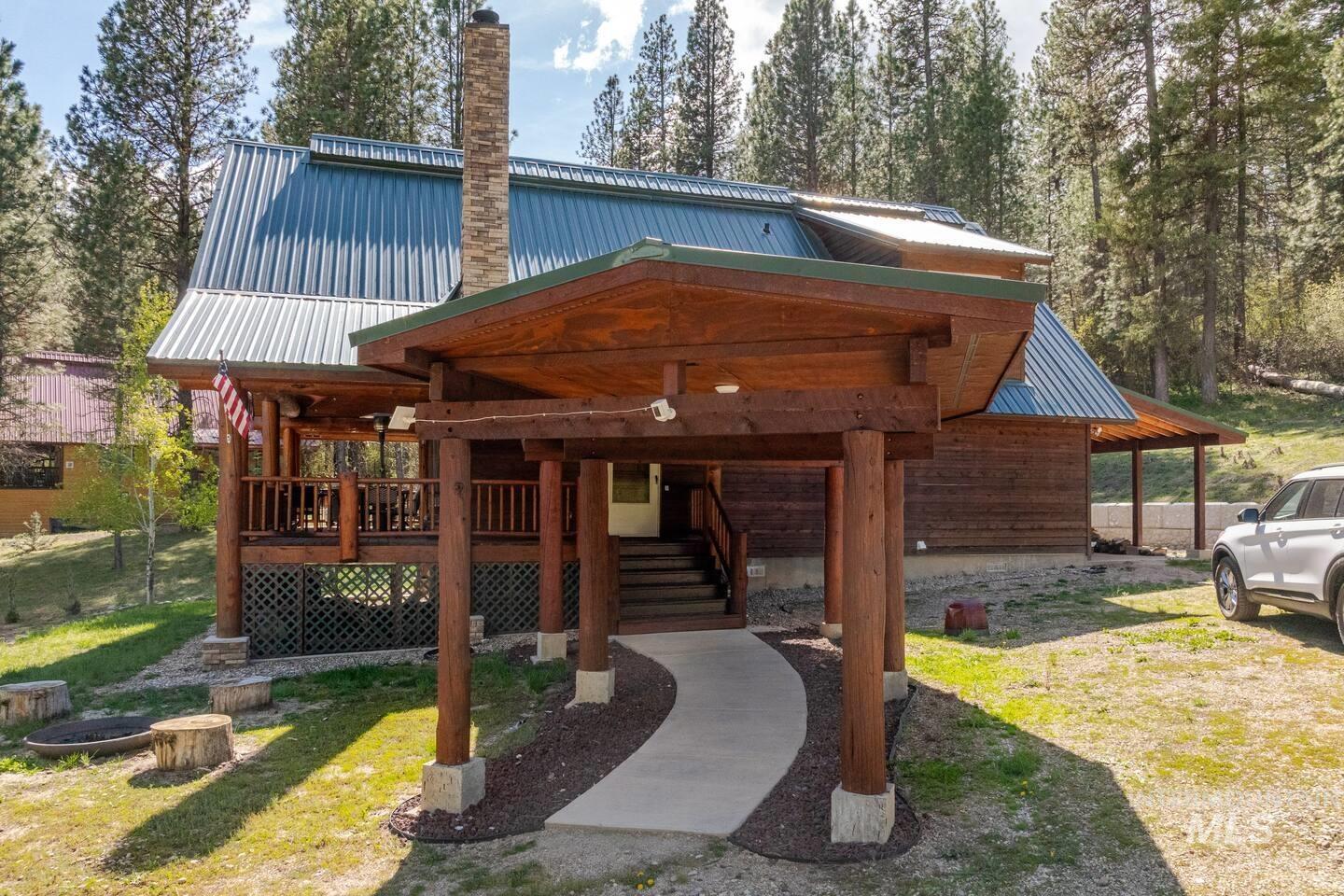 20 Valley High Road Garden Valley, ID 83622 - Photo 35 of 46 View of front facade with a metal roof, a front yard, and a chimney