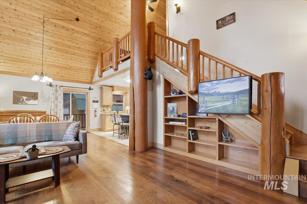 20 Valley High Road Garden Valley, ID 83622 - Photo 4 of 46 Living room with a high ceiling, wood-type flooring, wood ceiling, a chandelier, and stairs