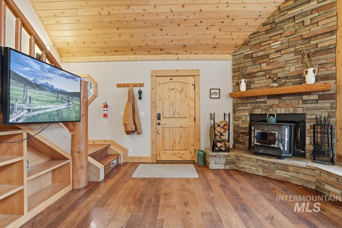 20 Valley High Road Garden Valley, ID 83622 - Photo 5 of 46 Entryway with vaulted ceiling, wooden ceiling, hardwood / wood-style flooring, and a wood stove
