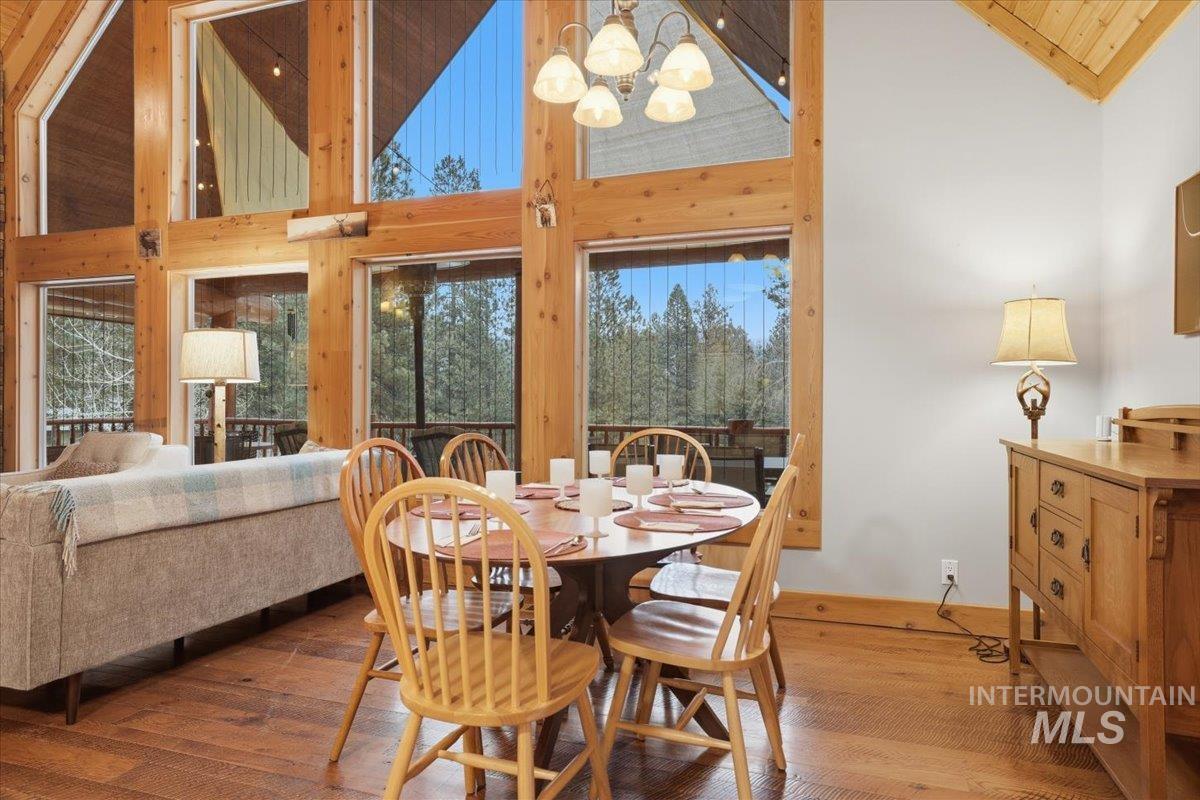 20 Valley High Road Garden Valley, ID 83622 - Photo 10 of 46 Dining area with high vaulted ceiling, hardwood / wood-style flooring, a chandelier, and wood ceiling