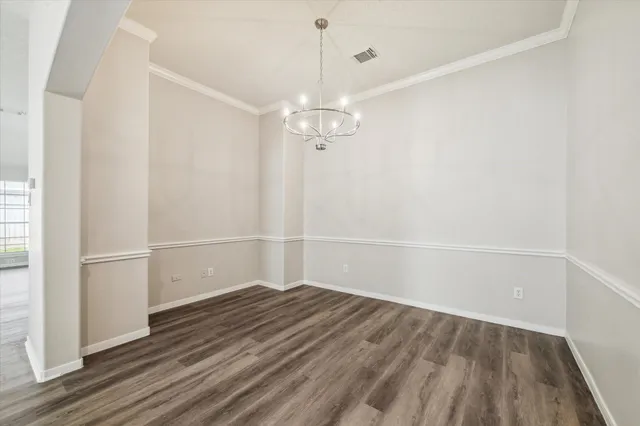 a view of a room with wooden floor