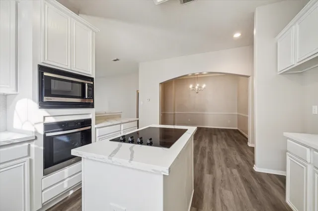 a kitchen with a sink and steel appliances