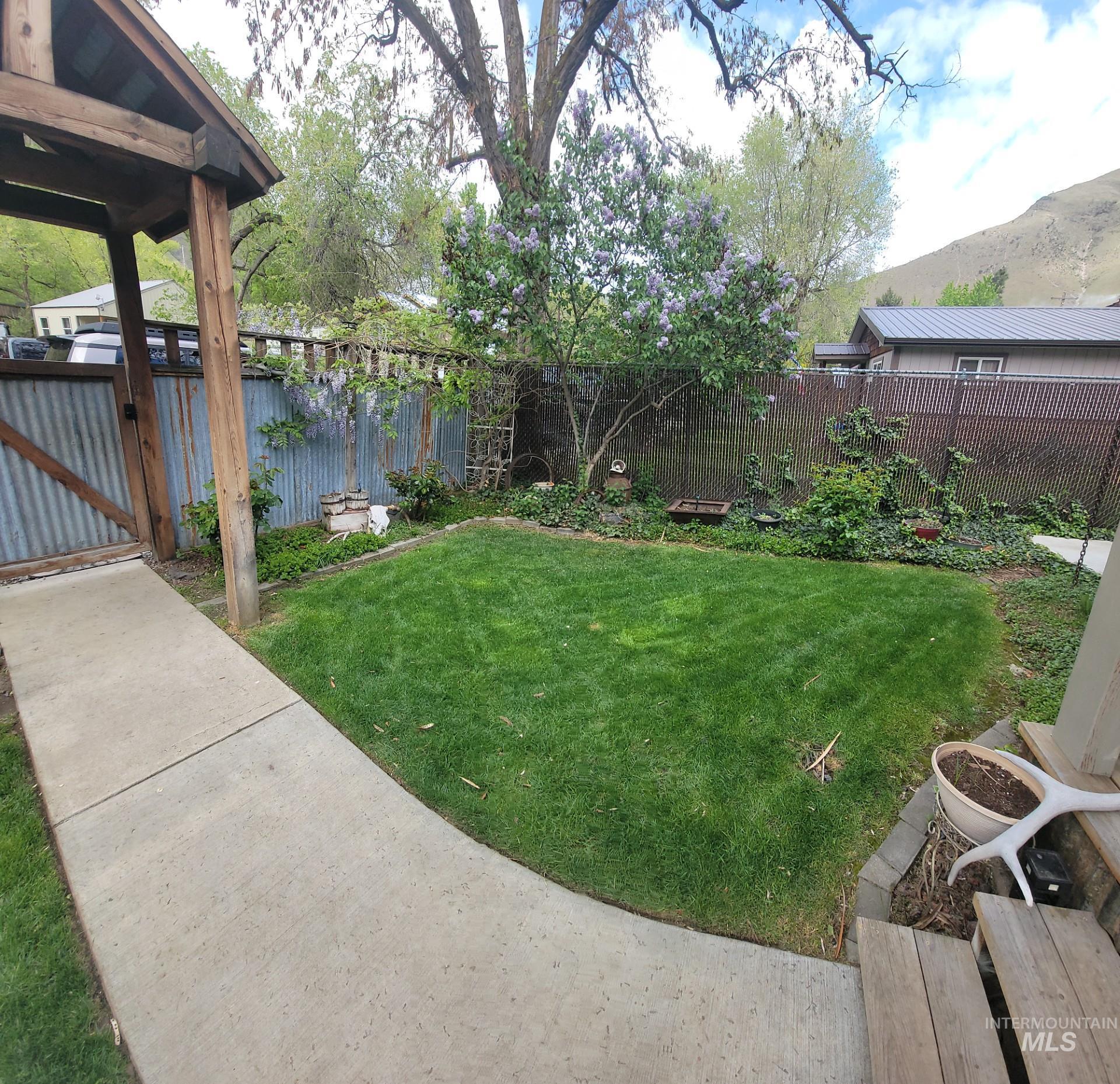1006 Borah Avenue Riggins, ID 83549 - Photo 4 of 23 Fenced backyard featuring a gate and a mountain view