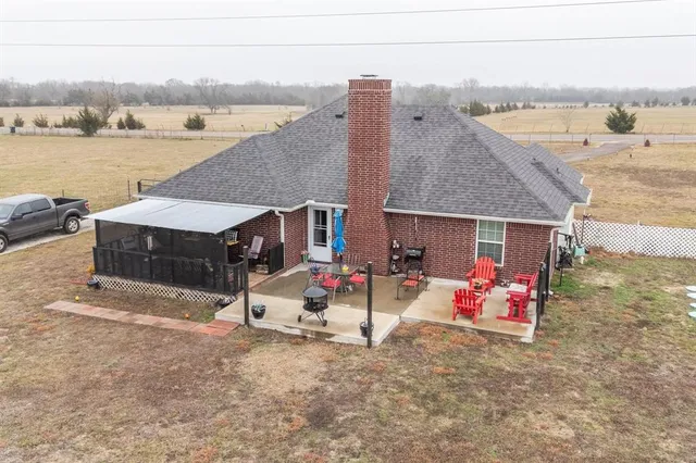 an aerial view of a house with outdoor seating