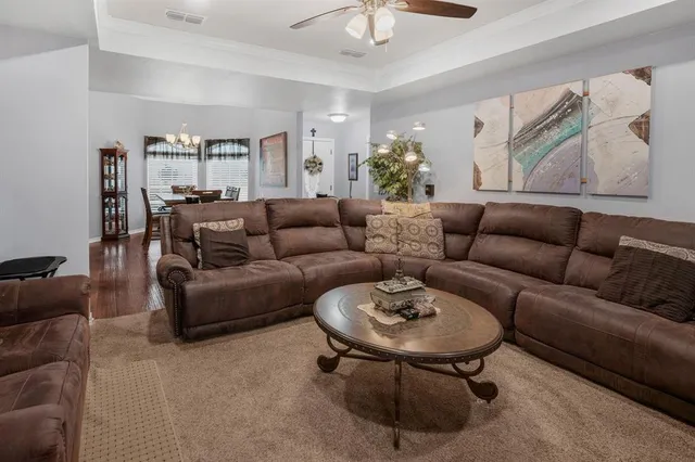 a living room with furniture and a potted plant