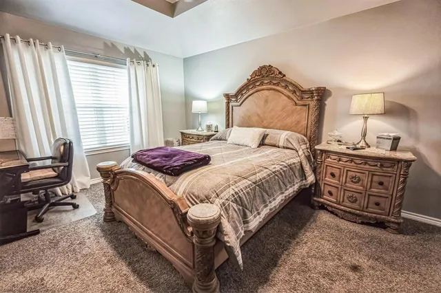 a bedroom with a bed and a dresser