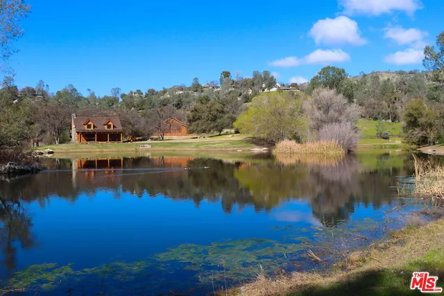 a view of pool with trees in the background