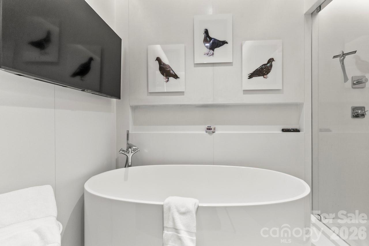 435 South Tryon Street, Unit 901 Charlotte, NC 28202 - Photo 19 of 28 a white bath tub sitting in a bathroom