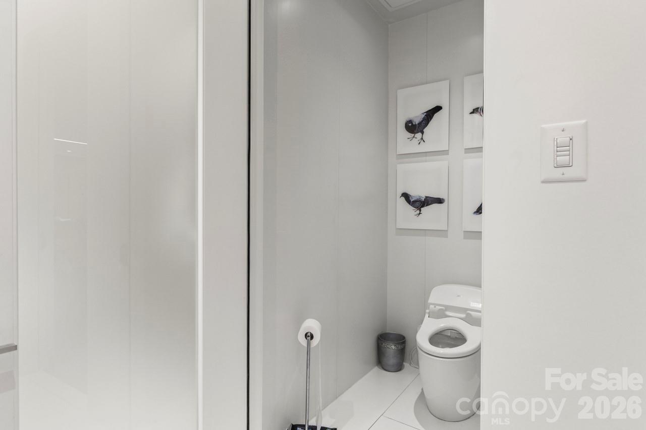 435 South Tryon Street, Unit 901 Charlotte, NC 28202 - Photo 20 of 28 a white toilet sitting next to a bathroom sink