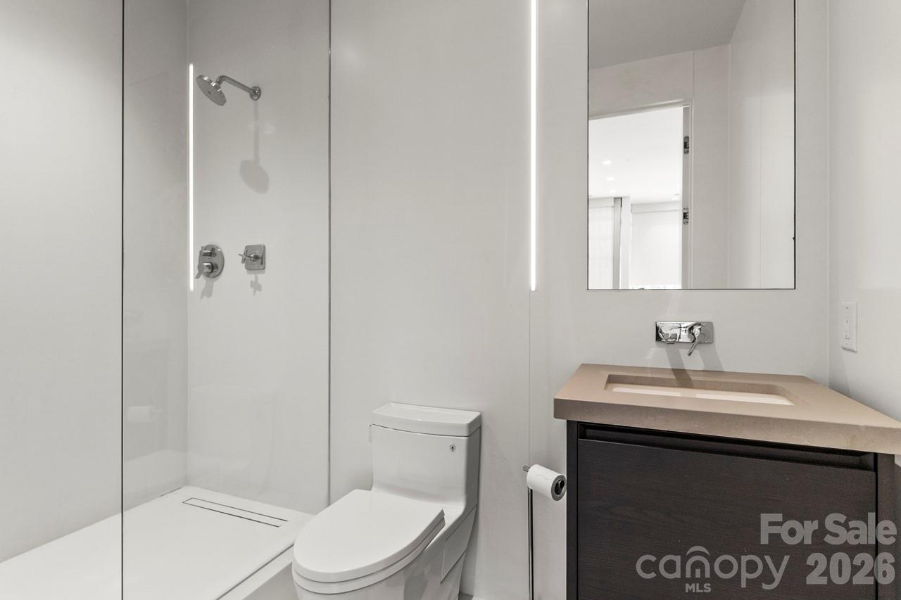 435 South Tryon Street, Unit 901 Charlotte, NC 28202 - Photo 24 of 28 a bathroom with a sink toilet and shower