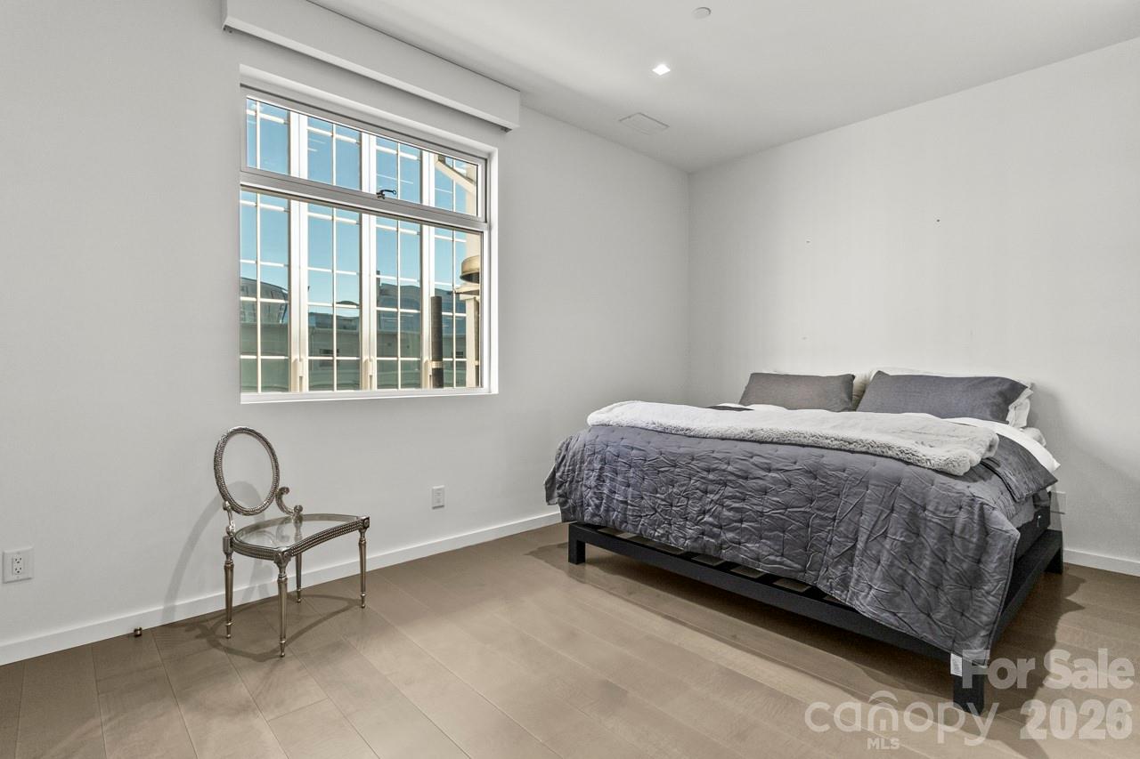 435 South Tryon Street, Unit 901 Charlotte, NC 28202 - Photo 25 of 28 a bedroom with a bed and a window