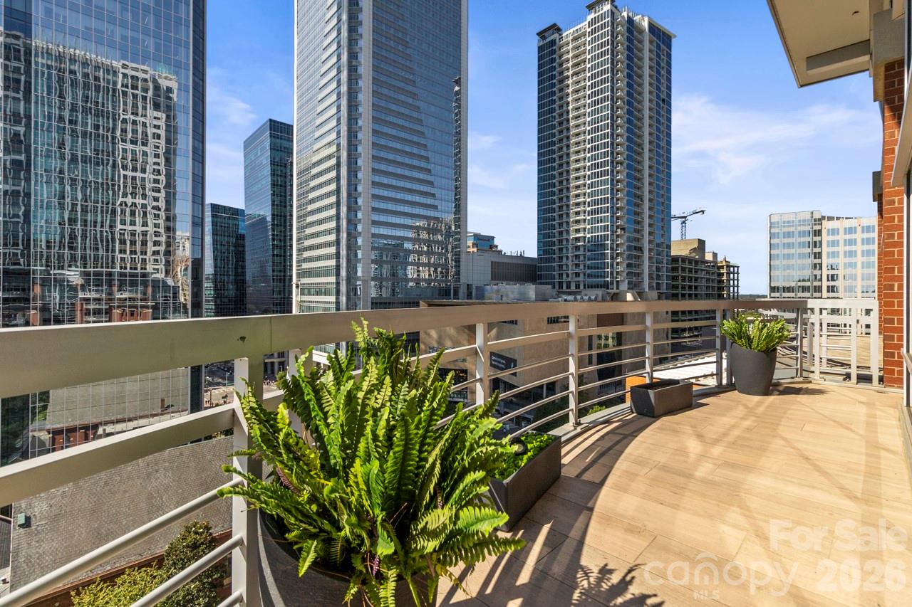 435 South Tryon Street, Unit 901 Charlotte, NC 28202 - Photo 4 of 28 a view of a balcony with chairs