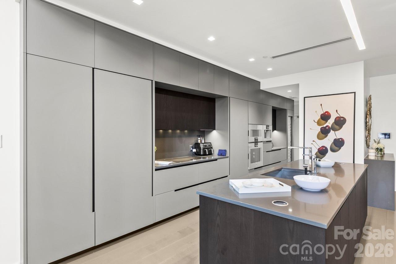 435 South Tryon Street, Unit 901 Charlotte, NC 28202 - Photo 9 of 28 a kitchen with a sink and refrigerator