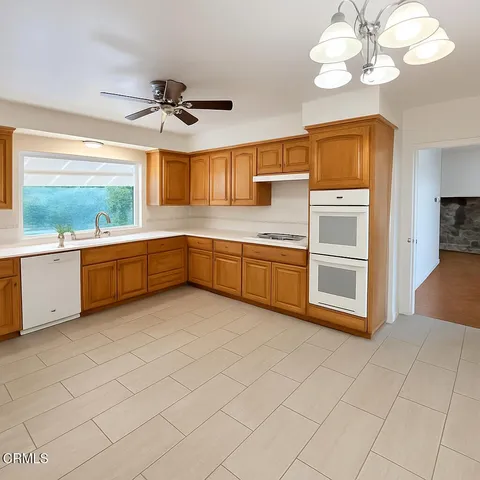 a view of a kitchen with a sink and cabinet
