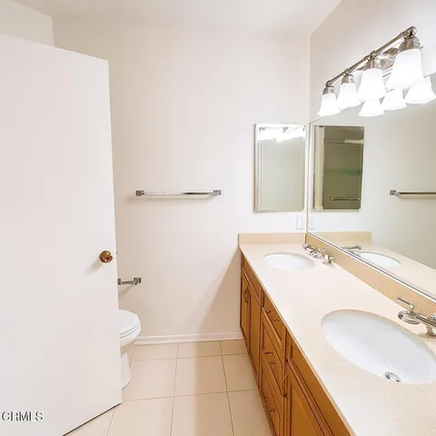 a bathroom with a double vanity sink mirror and double