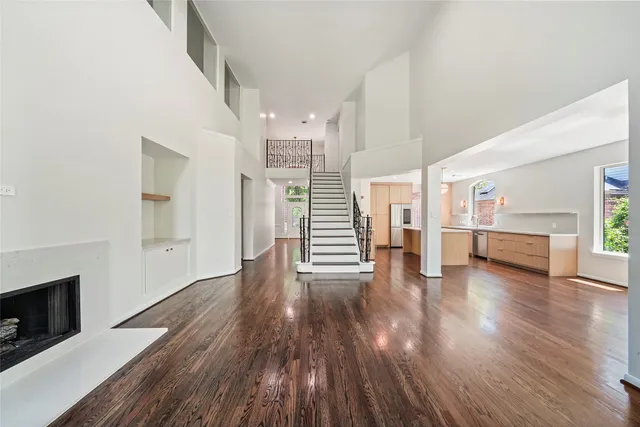 a view of empty room with wooden floor and fireplace