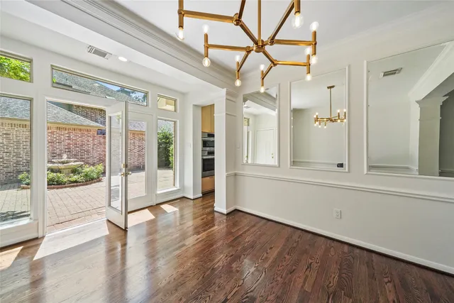 a view of a house with a yard and potted plants