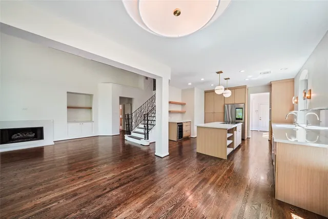 a large kitchen with a lot of counter space and wooden floor