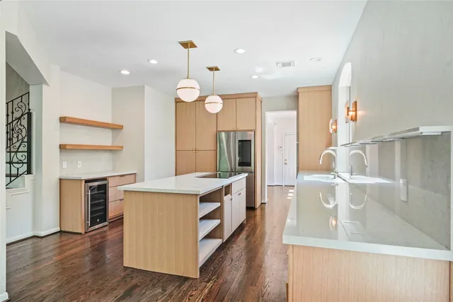 a view of a kitchen island wooden floor and windows