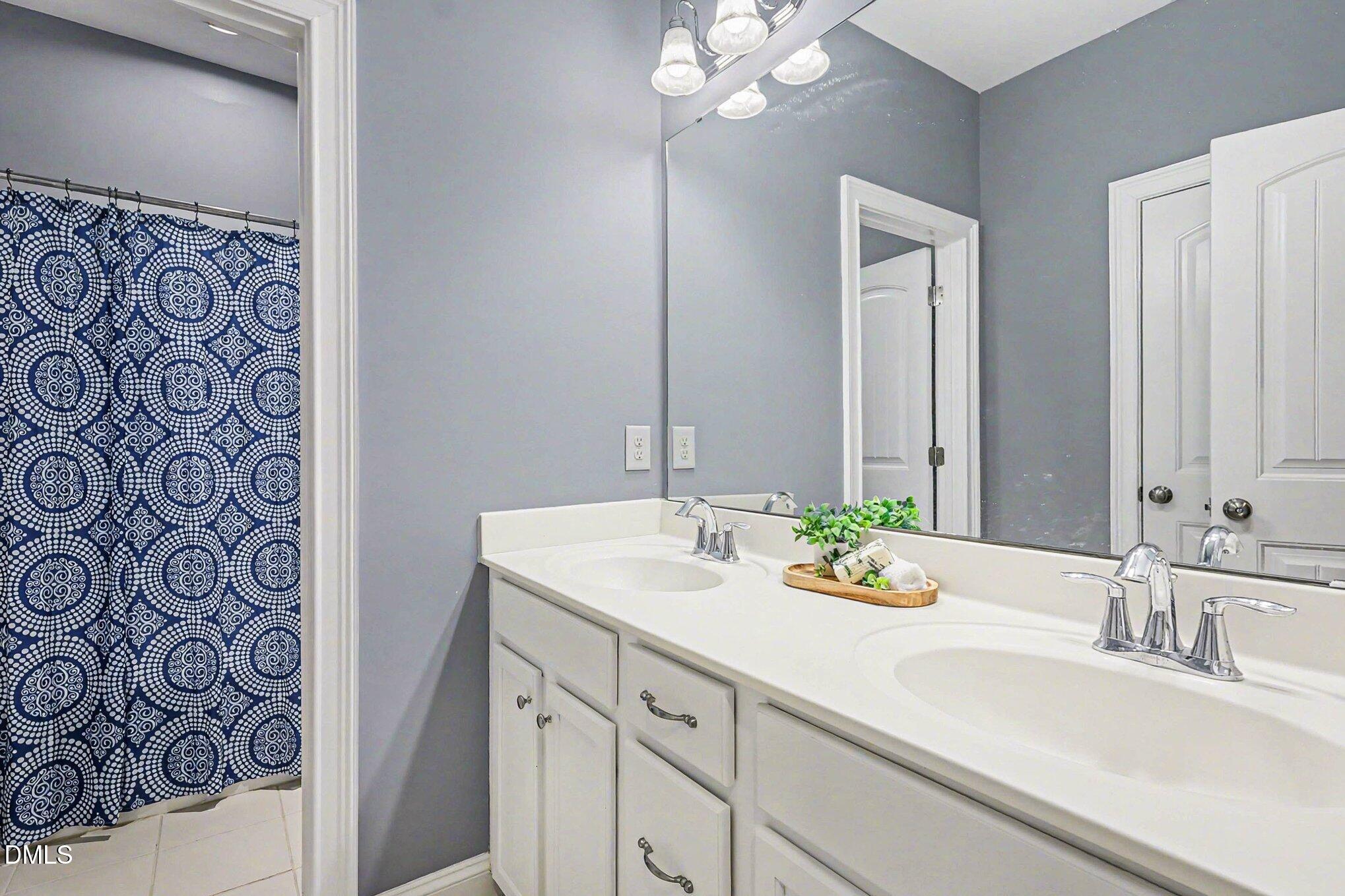 653 Fallon Grove Way Raleigh, NC 27608 - Photo 17 of 38 a bathroom with a sink and a mirror
