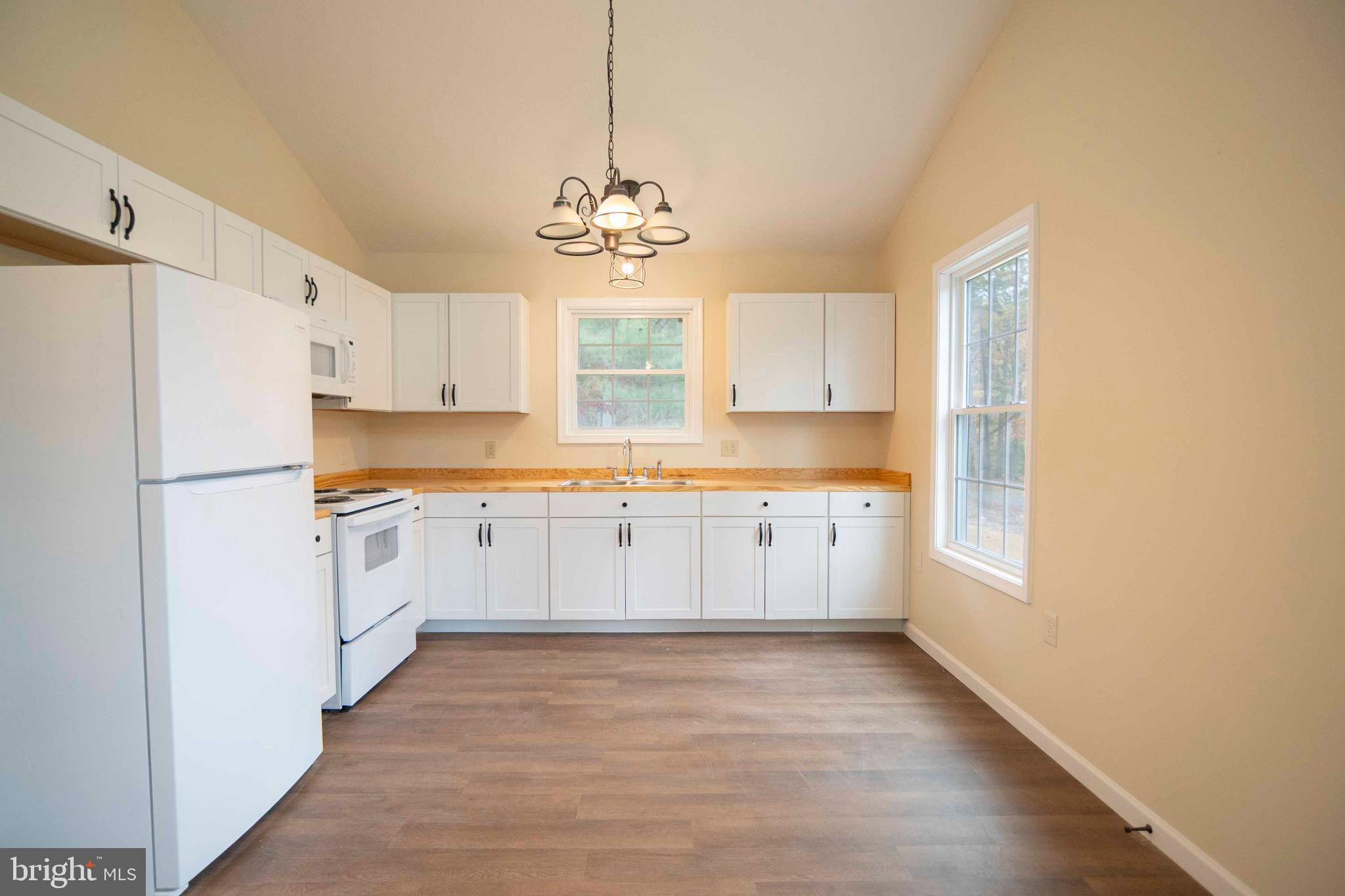 161 Ridge Loop Luray, VA 22835 - Photo 11 of 30 a large kitchen with cabinets wooden floor and stainless steel appliances