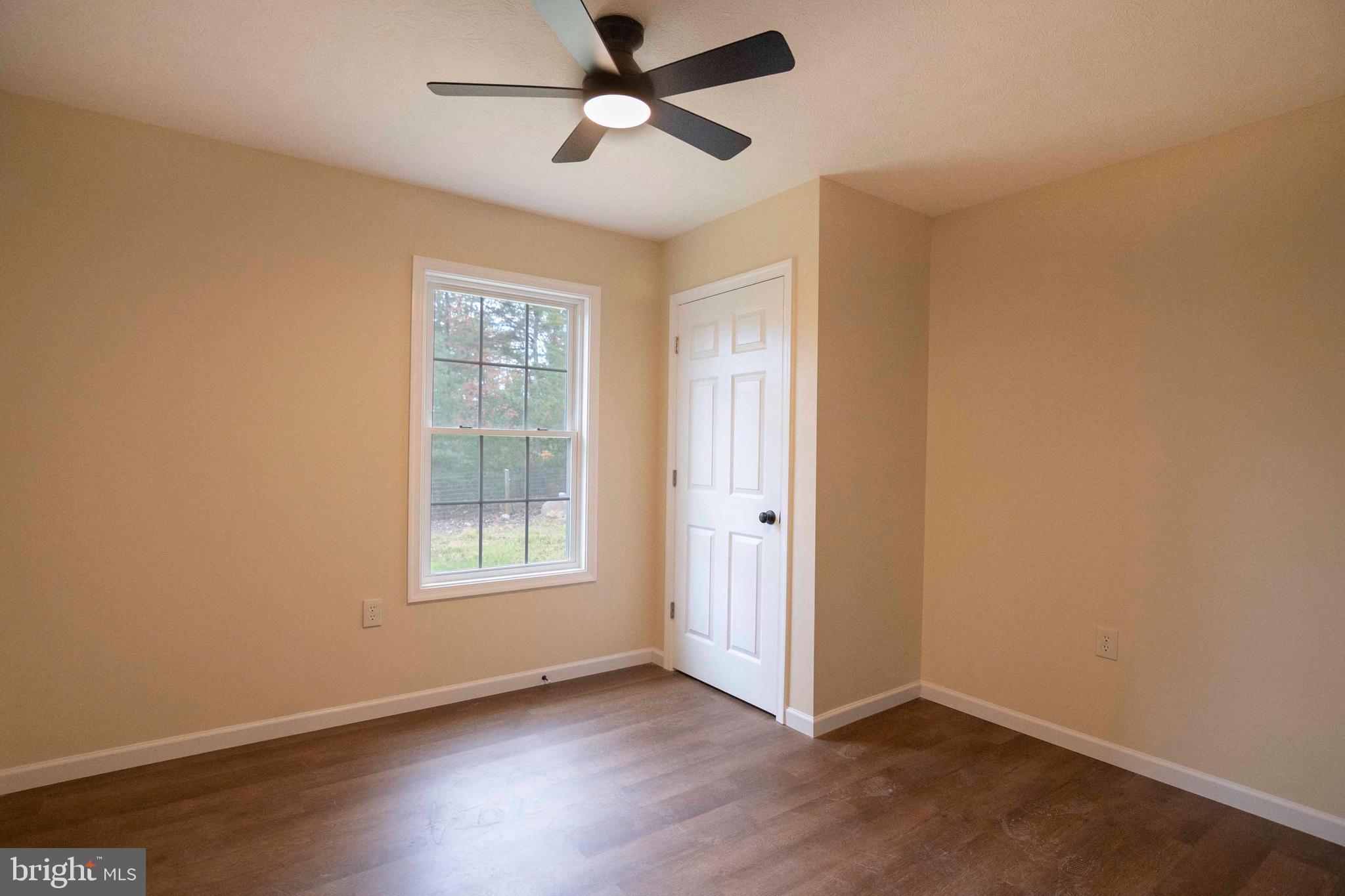 161 Ridge Loop Luray, VA 22835 - Photo 8 of 30 an empty room with wooden floor ceiling fan and windows