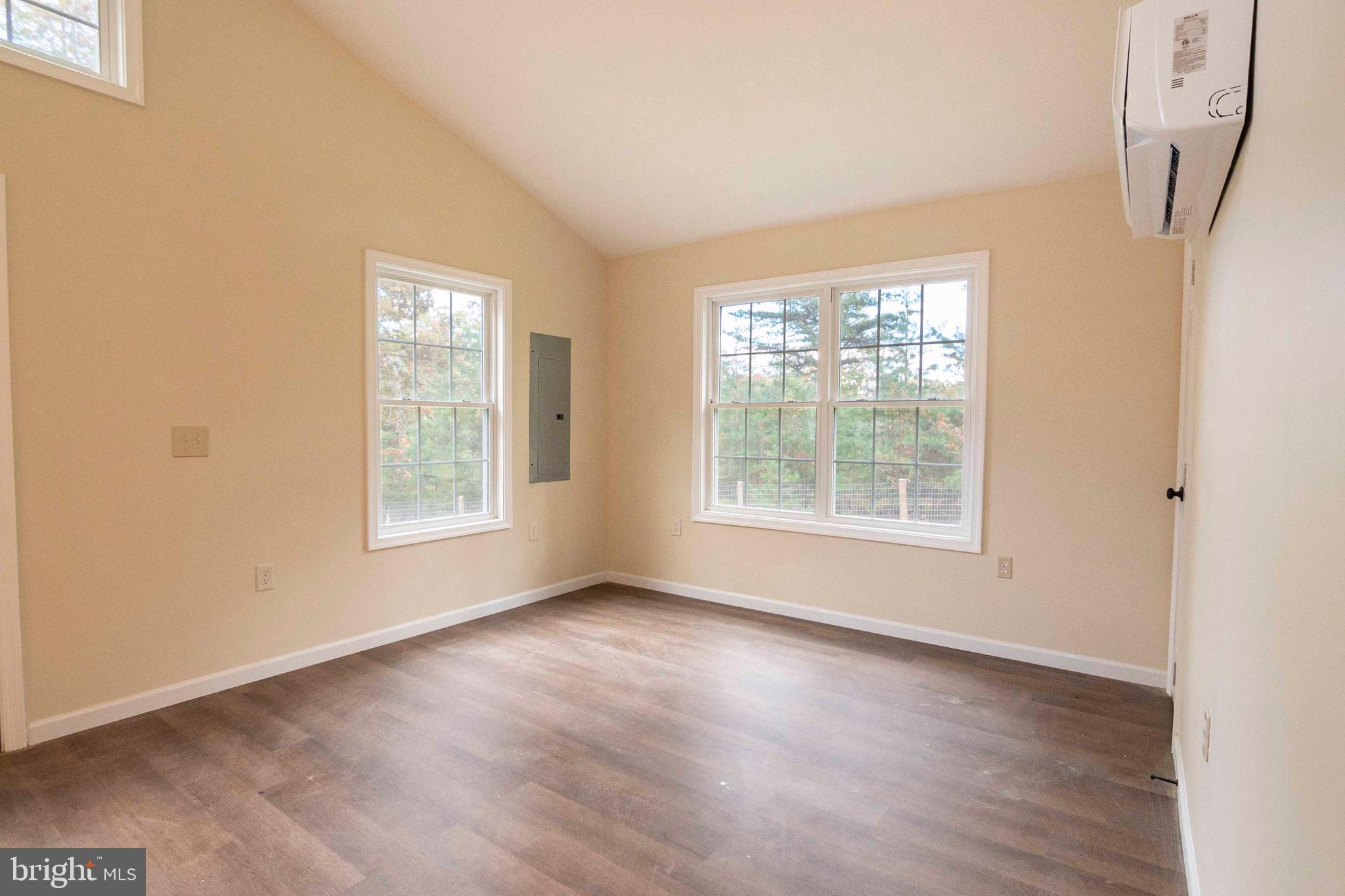 161 Ridge Loop Luray, VA 22835 - Photo 10 of 30 a view of an empty room with wooden floor and a window