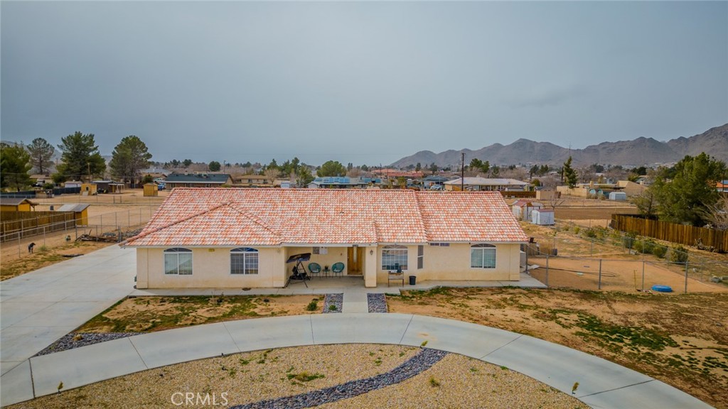 15540 Comanche Road Apple Valley, CA 92307 - Photo 1 of 1 a view of a house with a swimming pool and sitting area