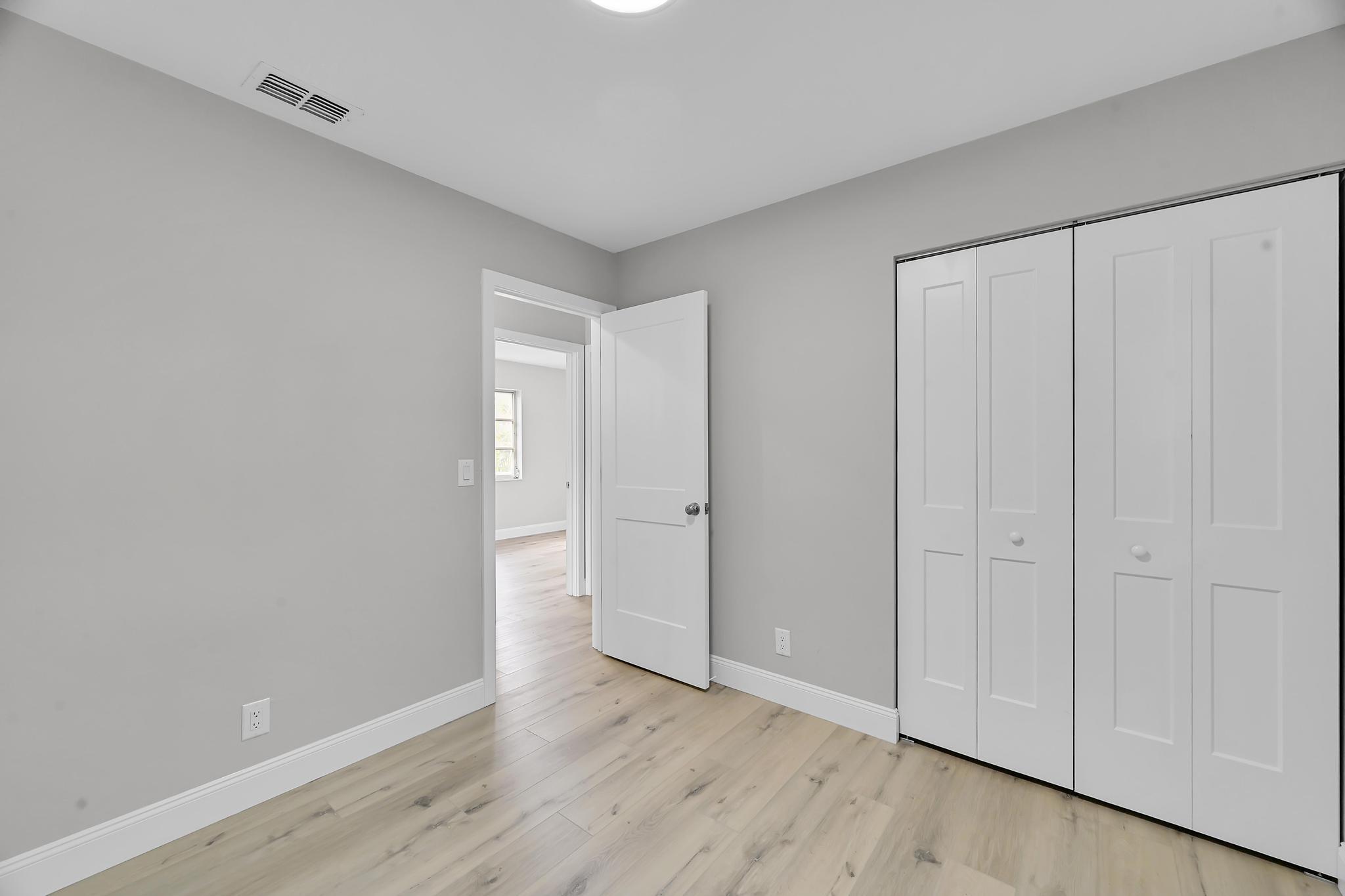 8487 Southeast Begonia Way Hobe Sound, FL 33455 - Photo 15 of 26 a view of an empty room and wooden floor