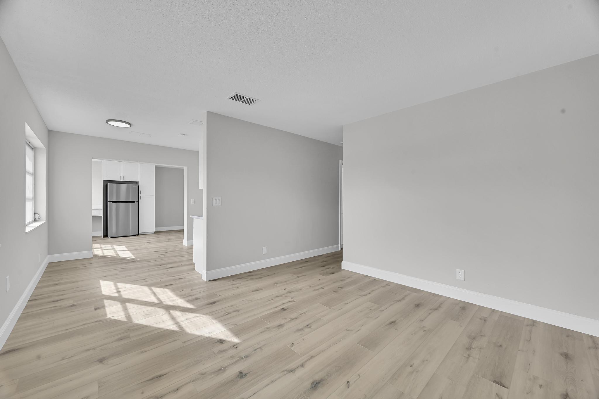 8487 Southeast Begonia Way Hobe Sound, FL 33455 - Photo 5 of 26 a view of empty room with wooden floor
