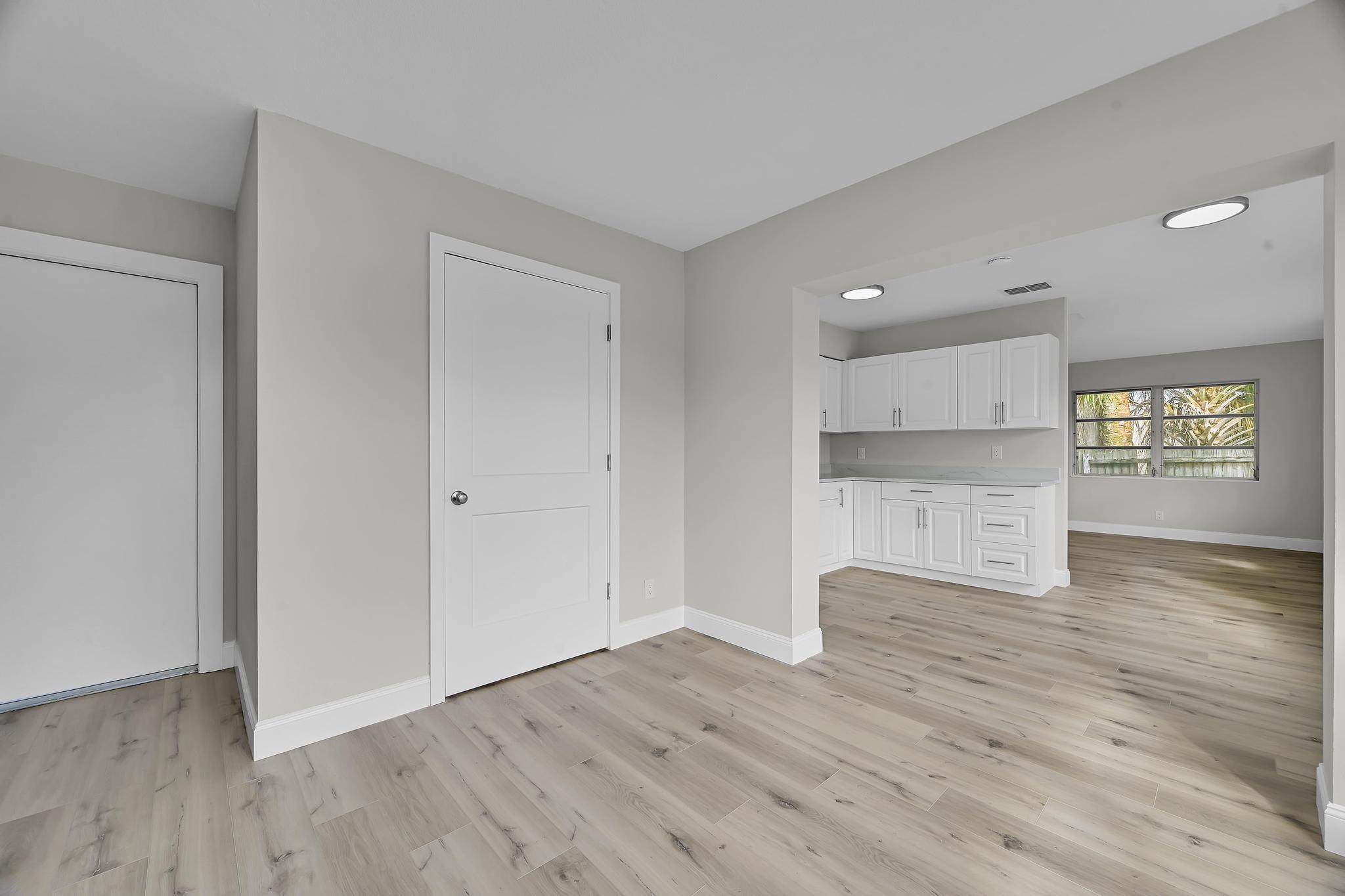 8487 Southeast Begonia Way Hobe Sound, FL 33455 - Photo 10 of 26 a view of an empty room with window and wooden floor