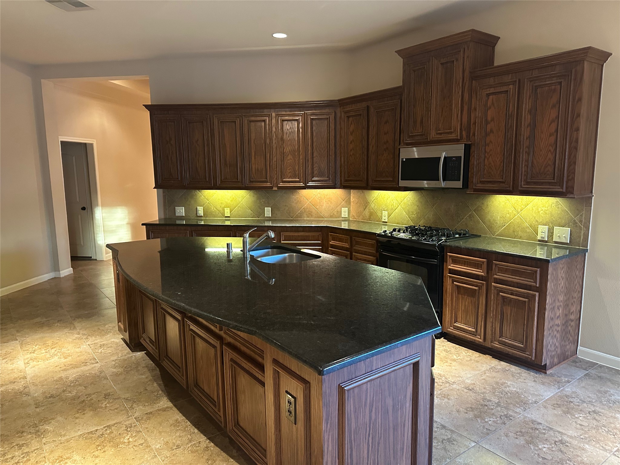 2922 Firewalk Trace Katy, TX 77494 - Photo 12 of 38 a kitchen with kitchen island granite countertop a sink a stove and a refrigerator