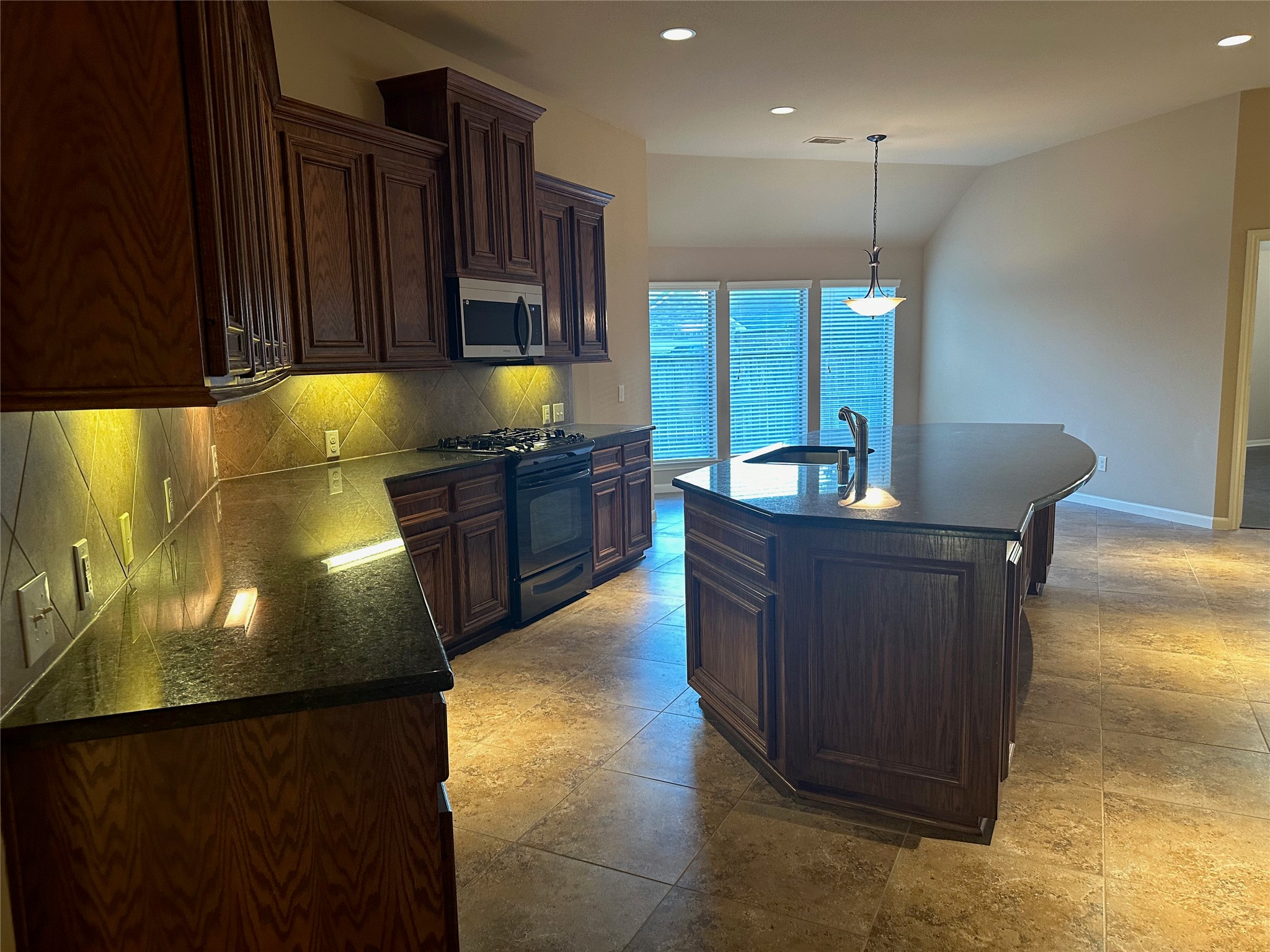 2922 Firewalk Trace Katy, TX 77494 - Photo 13 of 38 a kitchen with granite countertop a stove a sink and a refrigerator